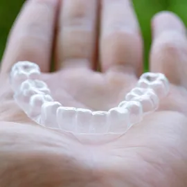 Patient with straight, healthy teeth after orthodontic treatment