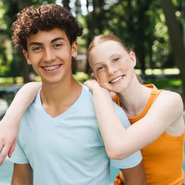 Happy family smiling together after successful orthodontic treatment